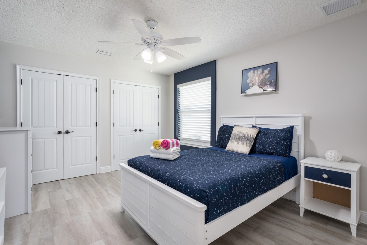 Space-themed third bedroom with queen bed