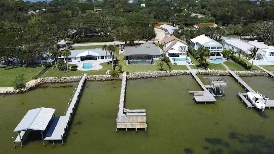 Aerial view of the home, pool and private dock on the Banana River