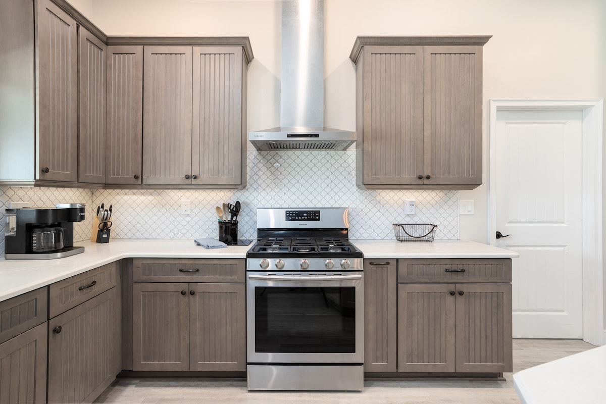 Quartz kitchen with island and stainless appliances