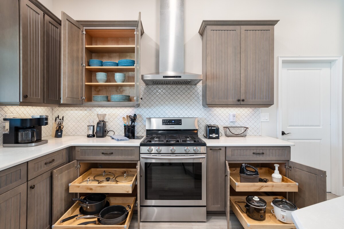 Stainless steel gas range with hood and organized pull-out cabinet storage